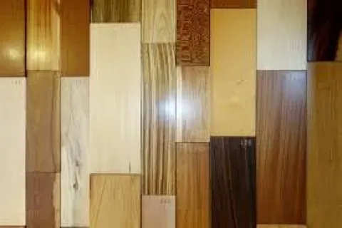 Variety of wooden planks with different grains, colors, and finishes arranged side by side in a grid.