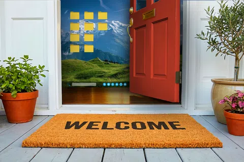 Open red door with welcome mat and potted plants revealing a desktop screen with folders and mountain wallpaper inside home.