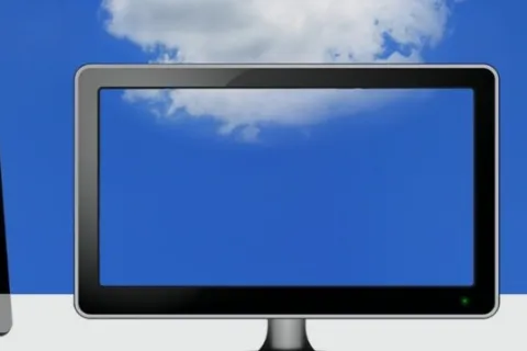 Three flat-screen monitors showing blue screens with a blue sky and white clouds background.