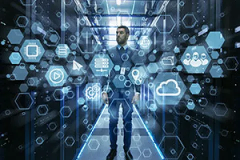 Businessman standing in server room surrounded by digital technology icons and data network holograms