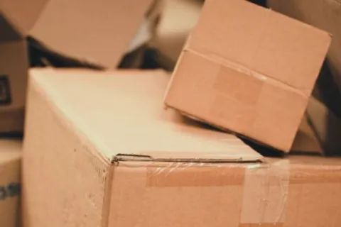 Stack of various sized brown cardboard boxes packed and taped, ready for shipping or storage.