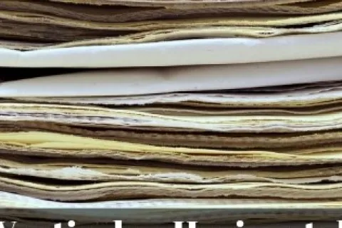 Stack of folded paper with text overlay asking vertical or horizontal choice for company strategy.