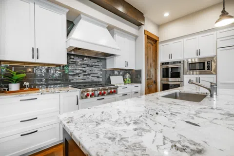 Modern kitchen with marble countertops, stainless steel appliances, and sleek cabinetry.