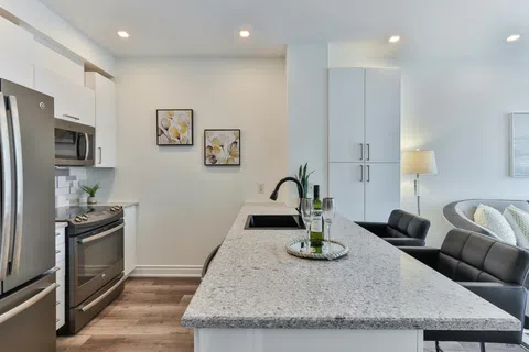 Modern kitchen with stylish cabinetry, granite countertops, and elegant decor, creating a cozy atmosphere.