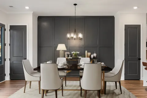 a dining room with a table and chairs