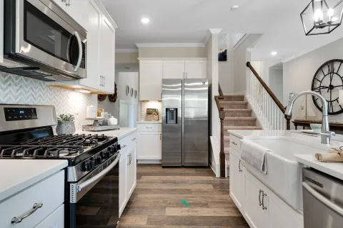 a kitchen with white cabinets