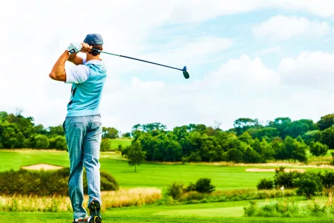 a man swinging a golf club