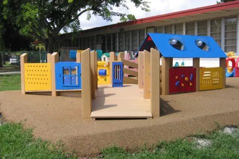 a small play structure outside of a building
