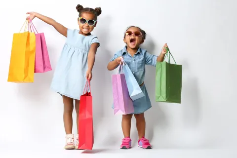 a couple of girls holding shopping bags
