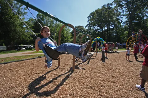 a child on an EcoPlay swing