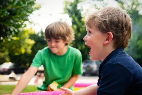 a couple of boys playing with a toy