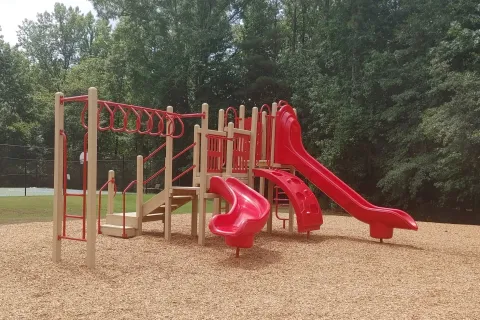 a playground with red slide