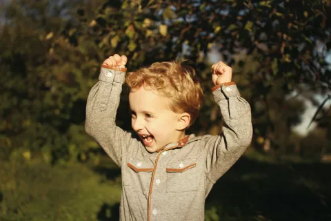 a child with autism flapping his hands
