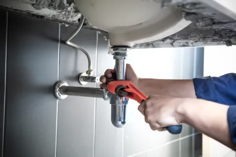 a person holding a faucet