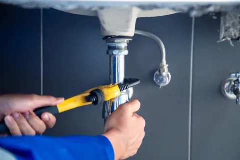 a person holding a yellow drill