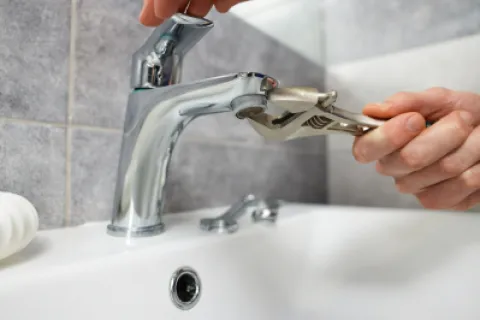 a person washing their hands in a sink