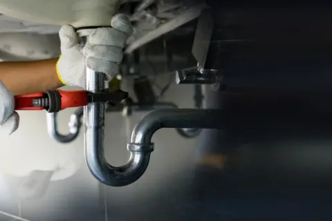 a person wearing gloves and a white lab coat holding a pipe