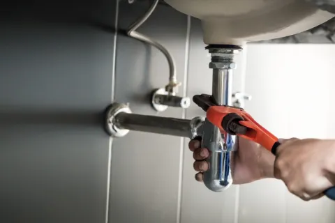 a person holding a faucet