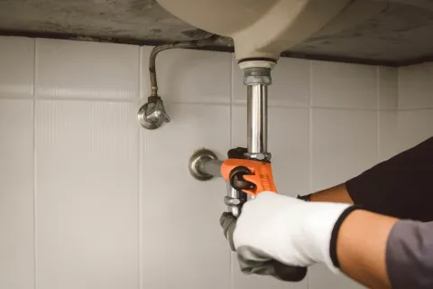 a person holding a faucet