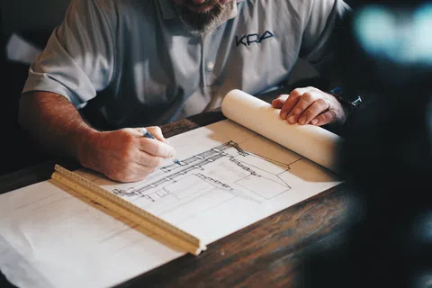 a man writing on a piece of paper