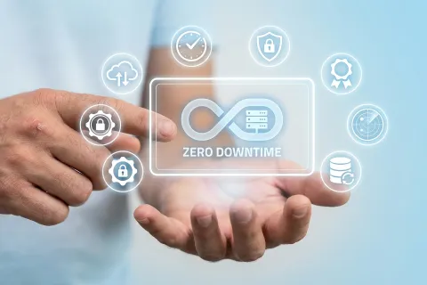 Person holding digital interface with infinity loop and zero downtime concept surrounded by security and data icons.