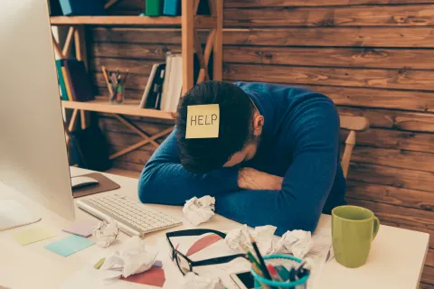 a person sleeping on a desk