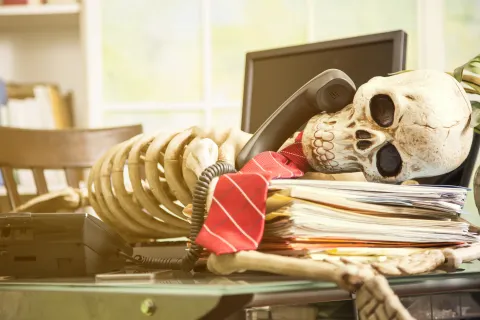 a skull and books on a table