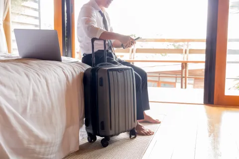 a man with a laptop and luggage