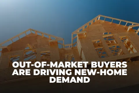 Wooden frame of a house under construction with text about out-of-market buyers driving new-home demand.