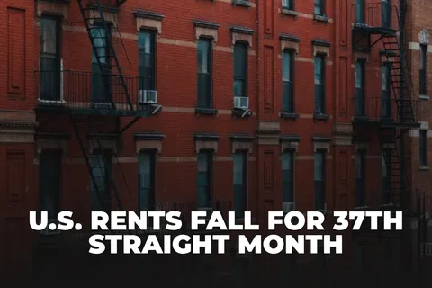 Red brick apartment building with fire escapes and headline about U.S. rents falling for 37th straight month.