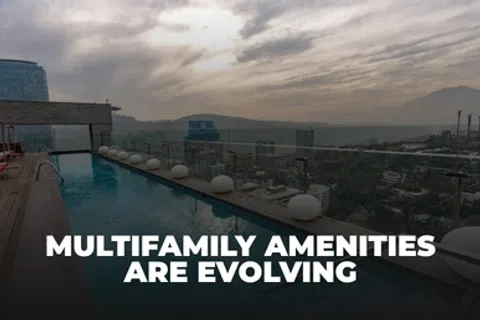 Rooftop pool with cityscape view at sunset highlighting evolving multifamily amenities