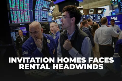 Stock traders analyzing data on screens with headline about Invitation Homes facing rental challenges