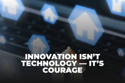 Text overlay reads Innovation isn't technology, it's courage with floating house icons over a laptop keyboard background.