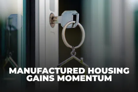 Key inserted in door lock with house-shaped keychain and manufactured housing gains momentum text overlay