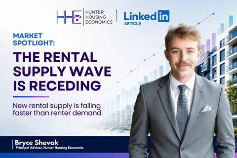 Young professional in suit stands beside text about declining rental supply in housing market spotlight.
