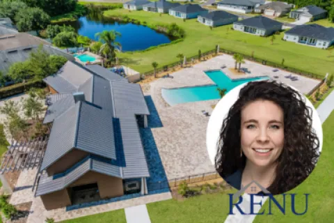 Aerial view of a modern house with a pool, landscaped yard, pond, and neighboring homes in a sunny neighborhood.