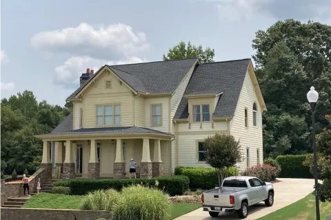 a white truck parked in front of a house