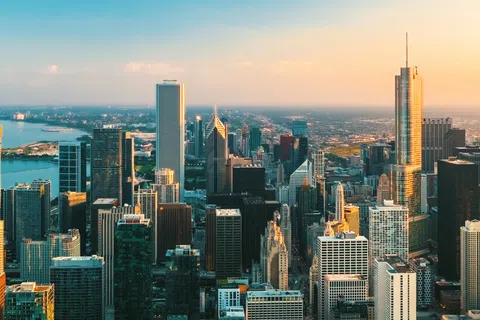 Chicago skyline at sunset with skyscrapers and Lake Michigan in the background under a clear sky
