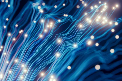 Blue fiber optic cables with glowing light points illustrating data transmission and digital connectivity.
