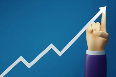 Hand pointing upward along a rising white arrow on blue background symbolizing growth and success.