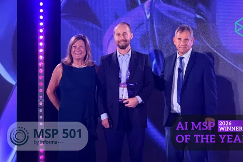Three professionals on stage at MSP 501 event with overlaid text reading AI MSP of the Year 2026 Winner