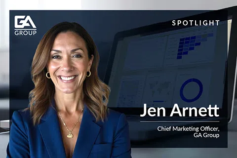 Professional portrait of Jen Arnett, Chief Marketing Officer at GA Group, with laptop displaying marketing data in background.