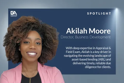 Portrait of Akilah Moore, Director of Business Development, smiling against a blue corporate background with text.