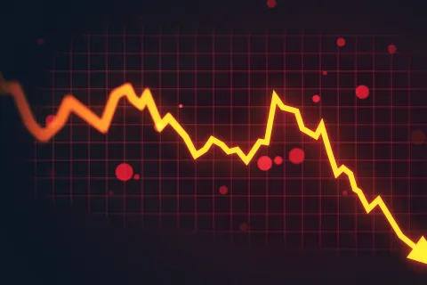 Yellow and orange line graph trending sharply downward over a red grid background symbolizing financial loss