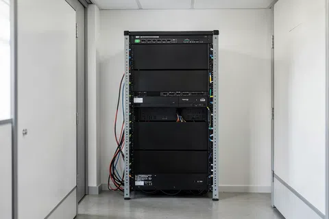 How should we compare two IT proposals if one is cheaper but excludes network projects and onsite work?