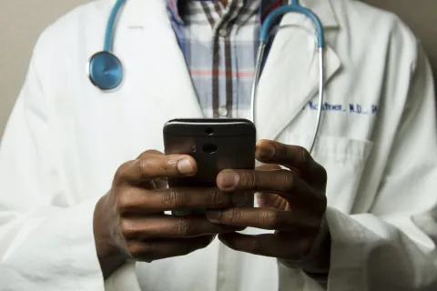 a doctor holding a phone