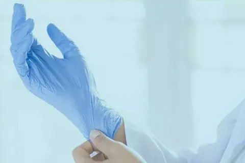 a hand holding a blue cloth