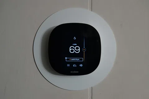 Modern smart thermostat on the wall of a Loganville, GA home, ready for spring HVAC maintenance.