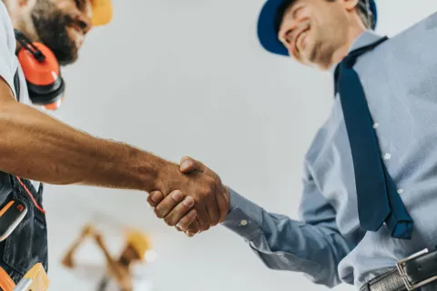 a man shaking hands with another man