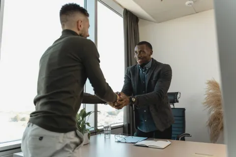 a man shaking another man's hand
